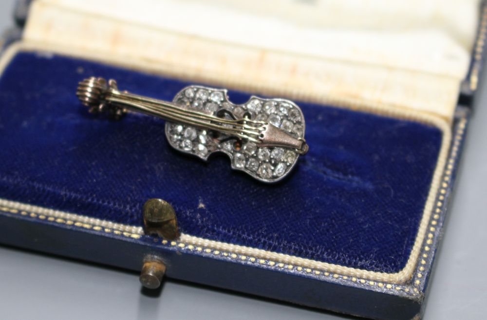 A late Victorian yellow and white metal and rose cut diamond set novelty brooch, modelled as a violin,